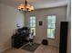 Well-lit office space with a desk, chair, and two windows at 9564 Venezia Plantation Dr, Orlando, FL 32829