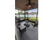 Enclosed patio with outdoor seating, ceiling fan, and views of the backyard and white vinyl fence at 9564 Venezia Plantation Dr, Orlando, FL 32829
