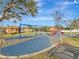 Community playground with play equipment for children at 9564 Venezia Plantation Dr, Orlando, FL 32829