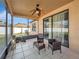 Relaxing screened porch with wicker furniture and ceiling fan at 9564 Venezia Plantation Dr, Orlando, FL 32829