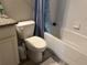 Compact bathroom featuring a toilet, vanity with granite countertop, and a shower/tub combo at 1341 Shinnecock Hills Dr, Davenport, FL 33896