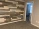 Bedroom features decorative wood accent wall and doorway to another room at 1341 Shinnecock Hills Dr, Davenport, FL 33896