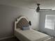 Bedroom with bed with a cushioned headboard, ceiling fan and a window with blinds at 1341 Shinnecock Hills Dr, Davenport, FL 33896