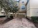Townhouse exterior featuring a two-car garage with brick paver driveway and stone accents at 1341 Shinnecock Hills Dr, Davenport, FL 33896