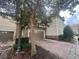 Townhouse exterior featuring a two-car garage with brick paver driveway and stone accents at 1341 Shinnecock Hills Dr, Davenport, FL 33896