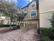 Townhouse exterior featuring a two-car garage with brick paver driveway and stone accents at 1341 Shinnecock Hills Dr, Davenport, FL 33896