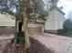 Townhouse exterior featuring a two-car garage with brick paver driveway and stone accents at 1341 Shinnecock Hills Dr, Davenport, FL 33896