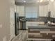Bright kitchen featuring white cabinets, stainless steel appliances, and tiled backsplash at 1341 Shinnecock Hills Dr, Davenport, FL 33896