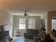 Cozy living room with neutral walls, ceiling fan, and comfortable sectional sofa at 1341 Shinnecock Hills Dr, Davenport, FL 33896
