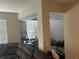 Open living area with views to another room and neutral walls at 1341 Shinnecock Hills Dr, Davenport, FL 33896