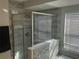 Bathroom featuring a glass enclosed shower with tile accents and a window for natural light at 1341 Shinnecock Hills Dr, Davenport, FL 33896