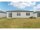 House rear view showing a grassy backyard at 2121 Rosewood Dr, Bartow, FL 33830