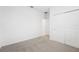 Bedroom with neutral carpet, closet, and door to bathroom at 2121 Rosewood Dr, Bartow, FL 33830