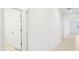 Bright hallway with light walls and neutral tile floors at 2121 Rosewood Dr, Bartow, FL 33830