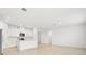 Open-concept kitchen with white cabinets, stainless steel appliances, and an island at 2121 Rosewood Dr, Bartow, FL 33830