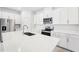 Modern kitchen with white cabinets, stainless steel appliances and island at 2121 Rosewood Dr, Bartow, FL 33830
