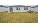 Large backyard with grassy lawn and sliding glass door access at 2125 Rosewood Dr, Bartow, FL 33830
