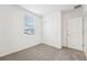 Bright bedroom with carpet flooring, window, and double-door closet at 2125 Rosewood Dr, Bartow, FL 33830