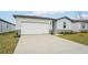 Front view of a one-story house with a two-car garage at 2125 Rosewood Dr, Bartow, FL 33830