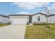 One-story house with a two-car garage, green door, and stone accents at 2125 Rosewood Dr, Bartow, FL 33830