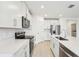 Modern kitchen with white cabinets, stainless steel appliances, and an island at 2125 Rosewood Dr, Bartow, FL 33830