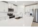 Modern kitchen with white cabinets, stainless steel appliances, and an island at 2125 Rosewood Dr, Bartow, FL 33830
