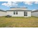 Home's backyard with grassy lawn at 2137 Rosewood Dr, Bartow, FL 33830