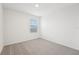 Simple bedroom with grey carpet and a window with blinds at 2137 Rosewood Dr, Bartow, FL 33830