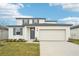 Two-story house with gray door and white siding at 2137 Rosewood Dr, Bartow, FL 33830
