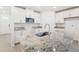 Modern kitchen with white cabinets, granite countertops and island at 2137 Rosewood Dr, Bartow, FL 33830