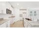 Modern kitchen with white cabinets, granite countertops and large island at 2137 Rosewood Dr, Bartow, FL 33830