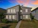 Modern two-story home with stone accents and landscaped yard at 4563 Narrative Ln, Kissimmee, FL 34746