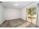 Bright bedroom with carpet flooring and sliding glass doors leading to a patio at 1704 Ison Ln, Ocoee, FL 34761