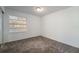 Cozy bedroom featuring a window with blinds and plush carpeting at 1704 Ison Ln, Ocoee, FL 34761