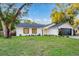 Charming single-story home nestled on a spacious lot with a lush lawn and mature trees at 1704 Ison Ln, Ocoee, FL 34761