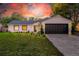 Recently updated home features a stylish exterior and a spacious driveway at 1704 Ison Ln, Ocoee, FL 34761
