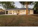 Rear view of the house showcasing landscaping and patio at 1704 Ison Ln, Ocoee, FL 34761
