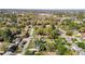 An aerial view shows the property nestled among lush trees with a swimming pool in the backyard at 4317 Ne 12Th St, Ocala, FL 34470