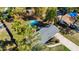 Aerial view of home features a kidney-shaped pool, large yard, and mature trees at 4317 Ne 12Th St, Ocala, FL 34470