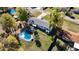 Aerial view of home featuring a kidney-shaped pool, patio, and large yard with mature trees at 4317 Ne 12Th St, Ocala, FL 34470