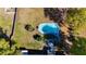 Aerial view of the backyard features a pool, a manicured lawn, and partial shade from mature trees at 4317 Ne 12Th St, Ocala, FL 34470