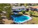 Aerial view of a backyard with a kidney-shaped pool, stone patio, and landscaped yard at 4317 Ne 12Th St, Ocala, FL 34470