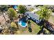 Aerial view of home featuring a kidney-shaped pool, patio, and lush green lawn at 4317 Ne 12Th St, Ocala, FL 34470