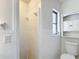 Clean bathroom featuring tiled shower, toilet, and built-in storage at 4317 Ne 12Th St, Ocala, FL 34470