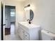 Well-lit bathroom with modern vanity, black hardware, and decorative mirror at 4317 Ne 12Th St, Ocala, FL 34470