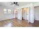 Bedroom features wood-look floors, closet with folding doors, and natural light at 4317 Ne 12Th St, Ocala, FL 34470