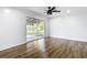 Bedroom with ceiling fan and sliding glass doors to a fenced backyard at 4317 Ne 12Th St, Ocala, FL 34470