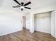 Bright bedroom features wood-look floors, closet with folding doors, and ceiling fan at 4317 Ne 12Th St, Ocala, FL 34470