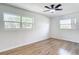Bright bedroom features two windows, hardwood flooring, and ceiling fan at 4317 Ne 12Th St, Ocala, FL 34470