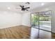 Bedroom with ceiling fan and sliding glass doors to a fenced backyard at 4317 Ne 12Th St, Ocala, FL 34470